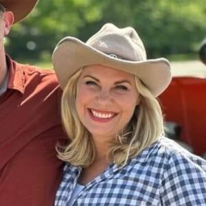 Chelsea's profile picture, in a cowboy hat smiling