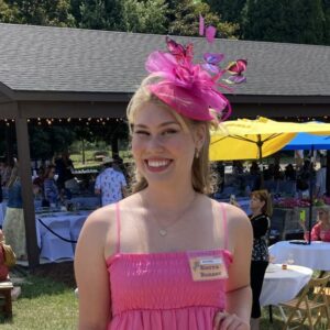 Sierra smiling in pink dress and fancy hat